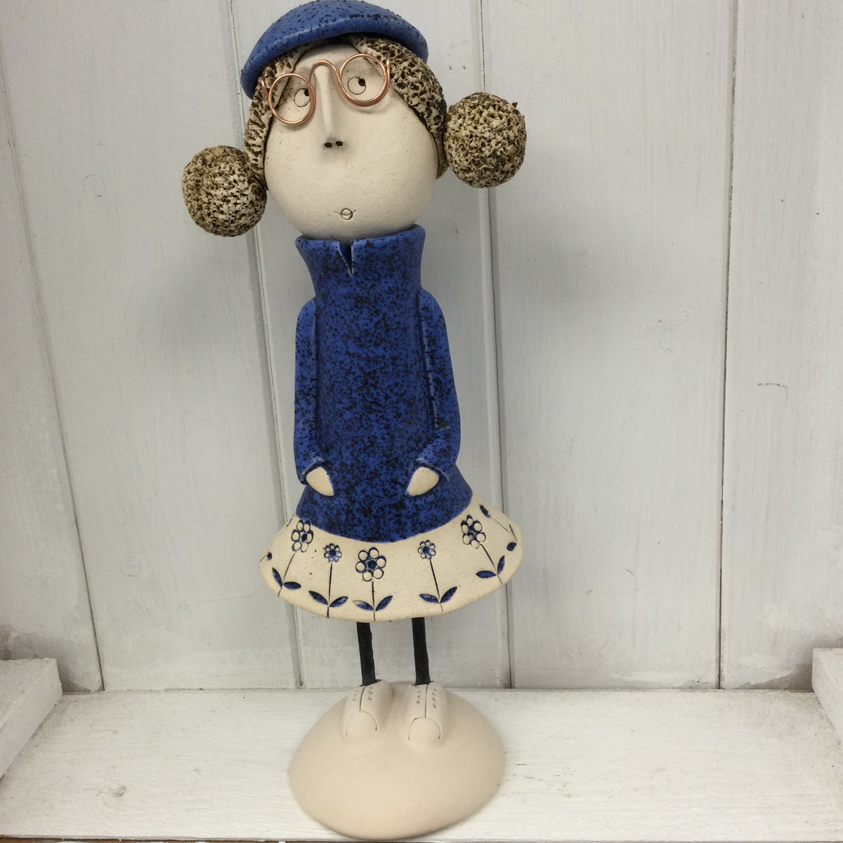 Ceramic Girl with rounded bunches and a beret in a Navy Dress